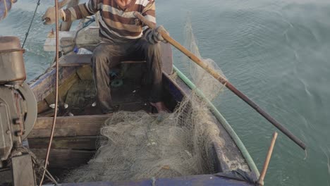 Traditional-Fishermen's-Art-of-the-Catch,-Traditional-Fishermen-Casting-Nets-from-his-traditional-boats-into-the-vast-ocean