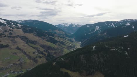 Saalbach-Hinterglemm-ski-resort-with-snowy-mountains-and-valleys,-aerial-view