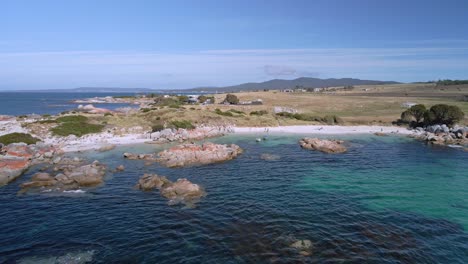 Wide-aerial-reveal-of-Bay-of-Fires-coastline-with-granite-rocks-and-turquoise-ocean,-Tasmania,-Australia