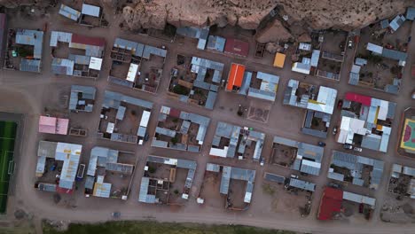 A-colorful-village-in-chile-with-structured-layout-at-dusk,-aerial-view