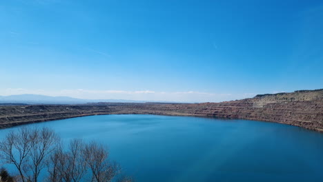 Time-lapse-of-a-huge-lake-with-blue-water-in-an-abandoned-copper-mine-in-Kremikovtzi-Bulgaria