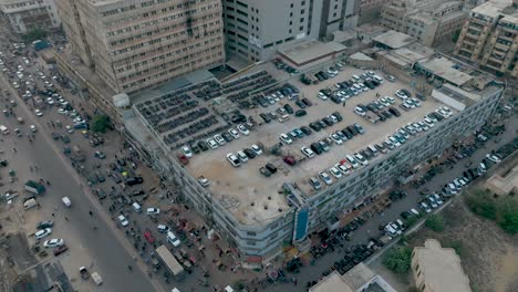 A-drone-glides-over-Gul-Plaza-Market-in-Karachi,-offering-a-bird's-eye-view-of-the-bustling-bazaar