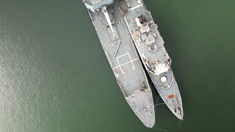 Overhead-Zoom-out-Aerial-View-of-a-Couple-of-Ships-Abandoned-in-the-Water