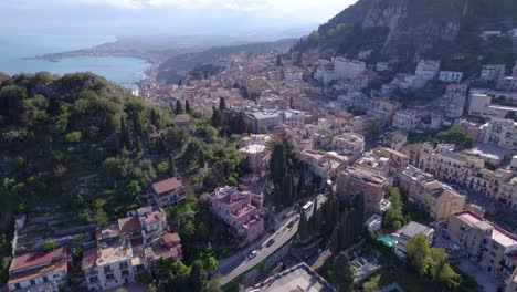 Aerial-descend-shot-of-Taormina,-Sicily,-Italy-a-famous-landmark,-north-side-of-the-city