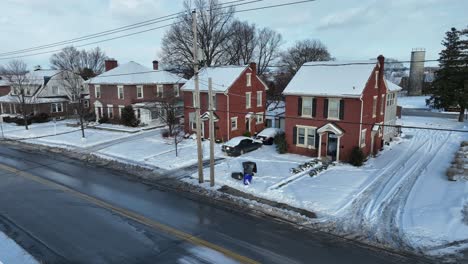 Aerial-establishing-shot-of-modest-brick-homes-with-snow