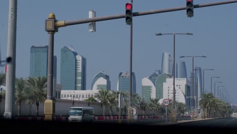 Abu-Dhabi-UAE-Cityscape-Skyline-and-Street-Traffic-on-Hot-Sunny-Day,-View-From-Vehicle