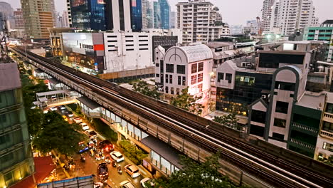 Timelapse-of-a-vibrant-cosmopolitan-city,-showing-the-various-buildings-at-the-center-of-the-business-hub-and-the-sky-train-that-runs-through-the-main-thoroughfare-in-Bangkok,-Thailand