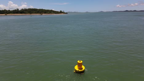 Overhead-aerial-clip-dollies-around-yellow-buoy-in-remote-northern-Australia