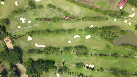 Directly-top-down-view-of-golf-course-with-water-hazard-and-bunker