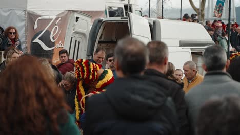 Caretos-Navigating-through-Onlookers,-Podence-Portugal