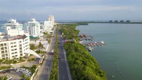 Cancun,-Quintana-Roo,-coast,-beach,-ocean,-roads,-trees,-cinematic-view,-aerial,-Playa-del-Carmen,-wide-shot-flying-over-the-coast