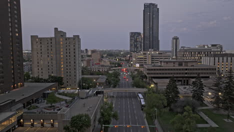 Calgary-AB-Canada-Aerial-v62-drone-flyover-downtown-commercial-along-5-Ave-SW-towards-riverfront-East-Village-capturing-urban-cityscape-and-Bow-river-at-dusk---Shot-with-Mavic-3-Pro-Cine---July-2023
