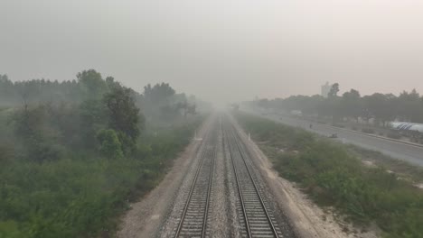 Aerial-View-Of-Empty-Railroad-Tracks-During-Morning-With-Misty-Air-In-Punjab