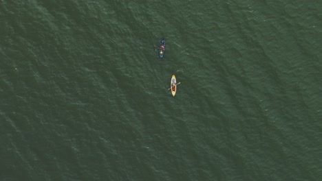 Two-kayaks-glide-peacefully-through-the-calm-waters-of-the-sea