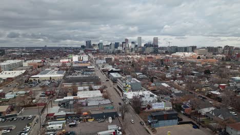 Panoramic-aerial-pullback-above-industrial-suburb-outside-of-Denver-Colorado-on-overcast-day