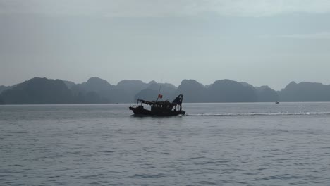 Fishing-Boat-Sailing-Across-Lan-Ha-Bay-In-The-Gulf-Of-Tonkin,-Vietnam