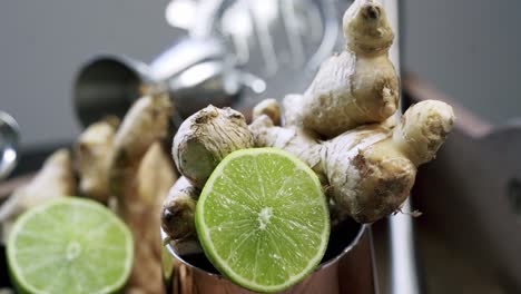 Circle-shot-around-a-cup-of-lime-and-ginger-root-natural-raw-ginger-root-spice-medicinal