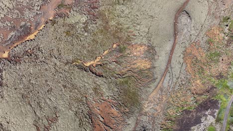 Birds-Eye-Aerial-View-of-Lava-Fields-and-Hills-in-Landscape-of-Iceland