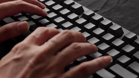 Hands-of-a-man-typing-text-on-a-mechanical-keyboard-without-printed-letters