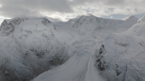 Incredible-world-famous-Gornergrat-Zermatt-Glacier-ice-crevasse-river-Swiss-Alps-top-The-Matterhorn-summit-ski-resort-landscape-scenery-aerial-drone-autumn-Railway-Switzerland-forward-reveal-motion