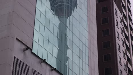 reflection-of-KL-Tower-in-the-windows-of-an-office-building-in-Kuala-Lumpur,-Malaysia