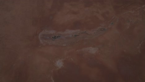 Bird's-eye-drone-clip-of-rock-formations-in-desert-ground,-in-outback-Western-Australia