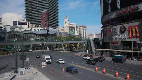 Las-Vegas-city-street-in-daytime-with-traffic,-people,-hotels-and-restaurants