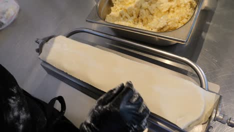 Chef-prepares-dough-and-fills-the-mold-to-create-dumplings