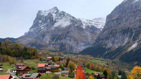 Grindelwald-gondola-ride-down-Switzerland-Swiss-Alps-valley-village-resort-ski-town-snowy-Jungfrau-Junfrangu-Lauterbrunnen-mountain-glacier-glacial-peaks-October-cloudy-autumn-evening-landscape