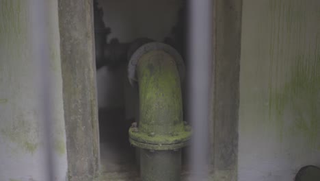 Old-water-pipes-overgrown-with-moss-and-corrosion