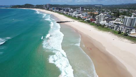 Ocean-Waves-Splashing-Sandy-Shore-Of-Palm-Beach-In-Gold-Coast,-Queensland,-Australia---Aerial-Drone-Shot