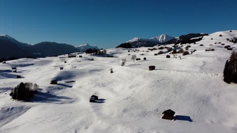 Rural-Austrian-landscape-during-winter-season-covered-in-snow,-aerial