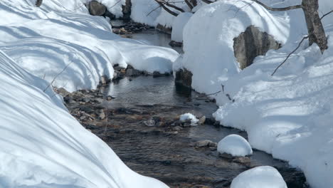 Winding-Mountain-Creek-or-Brook-in-a-Snow-Capped-Forest-in-Gangwon-do,-South-Korea