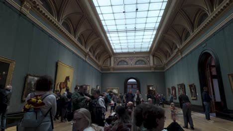 Gallery-visitors-stroll-through-National-Portrait-Gallery-in-London,-admiring-artworks,-the-concept-of-the-cultural-and-artistic-expression