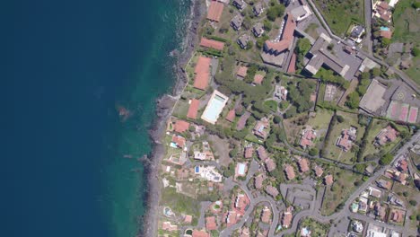 Aerial-top-down-shot-of-the-residential-village-on-the-Mediterranean-Sea-shore-near-Catania,-Sicily,-Italy