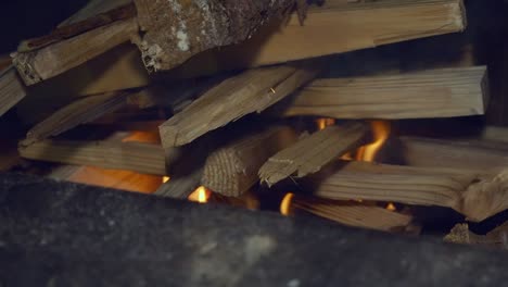 Dry-chopped-firewood-stacked-in-camp-fire-sags-as-it-burns-from-below