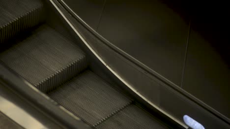 People-on-an-escalator-in-Stuttgart,-warmth-and-motion-in-focus,-indoors