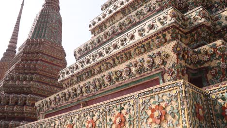 looking-up-at-towering-detailed-pagoda-spires-in-a-buddhist-temple-complex-in-the-Rattanakosin-old-town-of-Bangkok,-Thailand