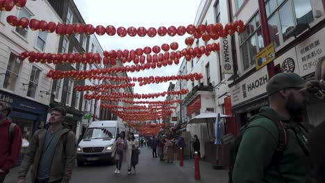 POV-Walking-Along-Chinatown-Gerrard-Street-In-London-With-Red-Hanging-Lanterns-Swaying-Overhead