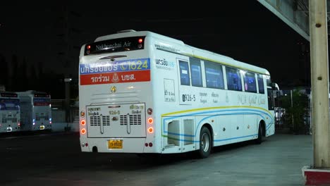 Newly-arrived-VIP-bus-parked-at-a-terminal-located-in-the-middle-of-a-bustling-city-of-Bangkok,-a-popular-tourist-destination-in-Southeast-Asia