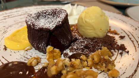 Delicious-molten-chocolate-lava-cake-with-vanilla-ice-cream-and-walnuts,-sweet-dessert,-4K-shot