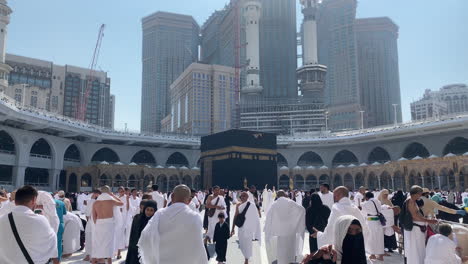 Diverse-Muslim-People-Performing-Hajj-or-Umrah,-Tawaf-for-Kaaba-on-Sunny-Day