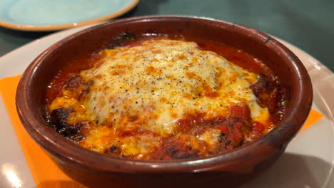 Traditional-Italian-eggplant-parmigiana-dish-with-melted-cheese,-4K-shot