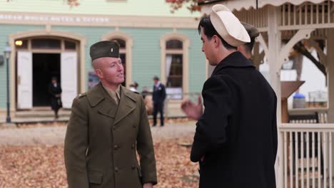 Reenactment-World-War-II-army-soldier-and-navy-sailor-chat-upon-their-return-to-the-united-states