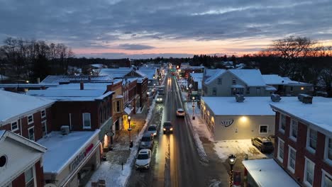 Rising-drone-shot-showing-snow-covered-downtown-of-small-American-town,-USA