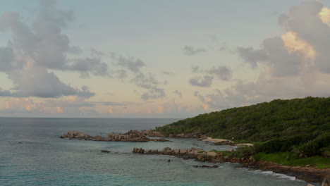 Pink-and-baby-blue-skies-during-sunset-over-a-beautiful-tropical-island