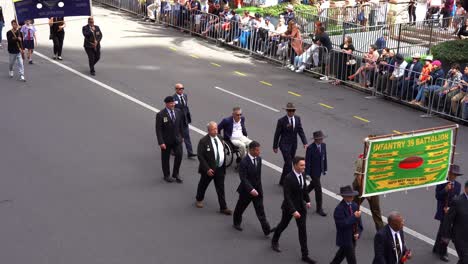 Representatives-from-the-39th-Australian-Infantry-Battalion-walking-down-the-street-of-Brisbane-city,-participating-Anzac-Day-parade