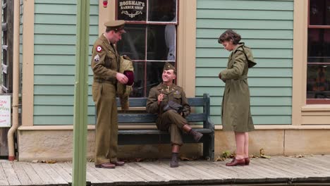 Reenactment-of-WWII-soldiers-and-USO-female-chat-in-front-of-barber-shop-at-the-Ohio-Village-at-the-Ohio-Connection-in-Columbus,-Ohio