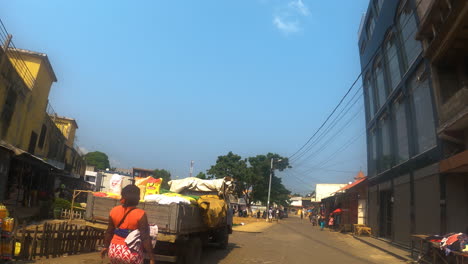POV-shot-driving-on-the-streets-of-the-Market-zone-in-Sao-Tome-city,-sunny-Africa
