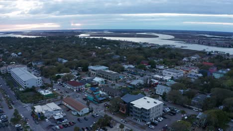 Aerial-reverse-pullback-and-panning-shot-of-downtown-Folly-Beach-on-Folly-Island-in-South-Carolina-at-sunset